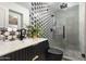 Stylish bathroom featuring a modern sink and black and white patterned shower and floors at 8708 E Rancho Vista Dr, Scottsdale, AZ 85251