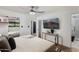 Contemporary bedroom with a ceiling fan, television, and a view of the en suite bathroom at 8708 E Rancho Vista Dr, Scottsdale, AZ 85251