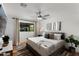 Cozy bedroom features a modern ceiling fan, plush bedding, and a large window with natural light at 8708 E Rancho Vista Dr, Scottsdale, AZ 85251