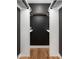 Walk-in closet with custom shelving, a dark painted back wall and wood flooring at 8708 E Rancho Vista Dr, Scottsdale, AZ 85251