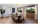 Elegant dining room with a rustic wood table, comfortable chairs, and brick accent wall at 8708 E Rancho Vista Dr, Scottsdale, AZ 85251