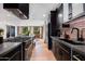 Gourmet kitchen with a professional-grade range, sleek black cabinets, and an open layout at 8708 E Rancho Vista Dr, Scottsdale, AZ 85251