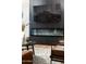 Modern living room with sleek black fireplace, flat-screen TV, and stylish accent chairs at 8708 E Rancho Vista Dr, Scottsdale, AZ 85251