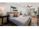 Bright main bedroom featuring a wood bed frame, light-colored walls, and stylish ceiling fan with a decorative light fixture at 8708 E Rancho Vista Dr, Scottsdale, AZ 85251