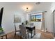 Bright office space with a modern chandelier, a dark wood desk, and hardwood floors at 8708 E Rancho Vista Dr, Scottsdale, AZ 85251