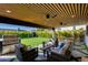 Inviting covered patio featuring comfortable seating, ceiling fans, and a built-in grill, perfect for outdoor entertaining at 8708 E Rancho Vista Dr, Scottsdale, AZ 85251
