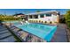 Modern pool and spa featuring sleek design elements, a sun lounger, and landscaping that enhances the backyard at 8708 E Rancho Vista Dr, Scottsdale, AZ 85251