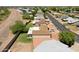 A high aerial view showing a quiet residential street of well-maintained desert homes and mature trees at 10018 N 97Th Dr # A, Peoria, AZ 85345