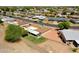 A residential aerial view showing neighboring homes, mature trees and desert landscaping on a sunny day at 10018 N 97Th Dr # A, Peoria, AZ 85345