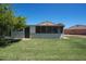 Backyard featuring a covered patio and a well-maintained lawn at 10018 N 97Th Dr # A, Peoria, AZ 85345