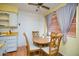 Cozy dining area with laminate floors, a round table, and natural light from the window at 10018 N 97Th Dr # A, Peoria, AZ 85345