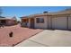 Charming single-story home with a simple front exterior and gravel landscaping at 10018 N 97Th Dr # A, Peoria, AZ 85345