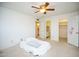 Bright main bedroom with neutral carpet and natural light; en-suite bathroom and closet entrances at 10018 N 97Th Dr # A, Peoria, AZ 85345
