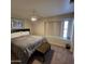 Inviting bedroom featuring a queen-sized bed, soft lighting, and a large window for natural light at 1032 E Sheffield Ave, Chandler, AZ 85225