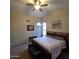 Comfortable bedroom with a king-sized bed, arched windows, and a ceiling fan for a restful retreat at 1032 E Sheffield Ave, Chandler, AZ 85225