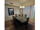Formal dining room with dark wood table, matching chairs, and modern light fixture at 1032 E Sheffield Ave, Chandler, AZ 85225