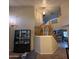 Grand foyer with staircase, elegant chandelier, and display cabinet, showcasing a bright interior at 1032 E Sheffield Ave, Chandler, AZ 85225