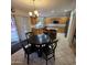 Eat-in kitchen featuring tile floors, wood cabinets, black appliances, and an island at 1032 E Sheffield Ave, Chandler, AZ 85225