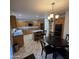 Kitchen featuring tile floors, wood cabinets, black appliances, and a central island at 1032 E Sheffield Ave, Chandler, AZ 85225