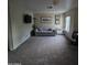 Spacious living room with neutral carpet, artwork, and a comfortable couch at 1032 E Sheffield Ave, Chandler, AZ 85225
