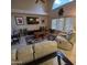 Bright living room with tile flooring, ceiling fan, large windows, and comfortable recliner seating at 1032 E Sheffield Ave, Chandler, AZ 85225