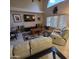 Bright living room with tile flooring, ceiling fan, large windows, and comfortable recliner seating at 1032 E Sheffield Ave, Chandler, AZ 85225