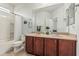 Bright bathroom with a double vanity, modern fixtures, and a shower-tub combination at 10412 W Cottontail Ln, Peoria, AZ 85383