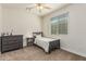 Comfortable bedroom featuring a bed, side table, dresser, and window with blinds at 10412 W Cottontail Ln, Peoria, AZ 85383