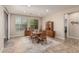 Bright dining room with a wooden table and chairs, complemented by natural light and stylish decor at 10412 W Cottontail Ln, Peoria, AZ 85383