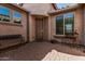 Cozy front porch with a brick-paved area, seating, and a welcoming entrance to the home at 10412 W Cottontail Ln, Peoria, AZ 85383