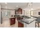Open-concept kitchen with island, granite countertops, stainless appliances, and stylish cabinetry at 10412 W Cottontail Ln, Peoria, AZ 85383
