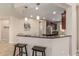 Stylish kitchen bar area with seating, pendant lighting, and granite countertops, perfect for entertaining at 10412 W Cottontail Ln, Peoria, AZ 85383