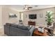 Cozy living room features tile floors, ceiling fan, neutral decor and comfortable seating at 10412 W Cottontail Ln, Peoria, AZ 85383