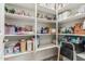 Well-organized pantry with shelves stocked with food items and storage containers at 10412 W Cottontail Ln, Peoria, AZ 85383
