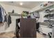 Organized walk-in closet with ample storage space, shelving, and a central island at 10412 W Cottontail Ln, Peoria, AZ 85383