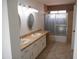 Bathroom features a double vanity, two oval mirrors, and a shower with decorative glass doors at 1044 N Abner --, Mesa, AZ 85205