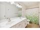 Bathroom featuring double sinks, modern fixtures, decorative mirror and a shower with glass door at 1044 N Abner --, Mesa, AZ 85205