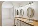 Bright bathroom featuring dual sinks and an arched entrance to another room at 1044 N Abner --, Mesa, AZ 85205