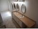 Bathroom features a double vanity with tan countertop and tiling plus a neutral colored tile floor at 1044 N Abner --, Mesa, AZ 85205