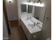 Bathroom vanity with double sinks, matching mirrors, tile floor and lighting fixture at 1044 N Abner --, Mesa, AZ 85205