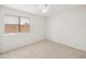 Neutral bedroom showcasing a ceiling fan, plush carpet, and a bright window at 1044 N Abner --, Mesa, AZ 85205
