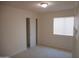 Empty bedroom featuring neutral carpet, white walls, window with blinds, and a closet at 1044 N Abner --, Mesa, AZ 85205