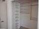 White closet features adjustable shelves, storage, and metal rods for hanging clothes at 1044 N Abner --, Mesa, AZ 85205