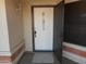 Close up of the home's white front door featuring glass block accents and a storm door at 1044 N Abner --, Mesa, AZ 85205