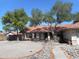 Charming single-story home with mature trees, tile roof, and easy to maintain rock landscaping at 1044 N Abner --, Mesa, AZ 85205