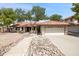 Charming single-story home featuring a red tile roof, desert landscaping, and an attached two-car garage at 1044 N Abner --, Mesa, AZ 85205