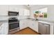 Bright kitchen with stainless steel appliances, updated cabinets, and a view of the backyard at 1044 N Abner --, Mesa, AZ 85205
