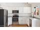 Modern kitchen with stainless steel appliances, white cabinetry, and a bright window over the sink at 1044 N Abner --, Mesa, AZ 85205