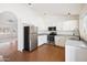Updated kitchen features white cabinets, stainless steel appliances, and an open layout to the living area at 1044 N Abner --, Mesa, AZ 85205