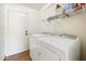 Efficient laundry room with washer, dryer, shelving for storage, and a utility sink at 1044 N Abner --, Mesa, AZ 85205